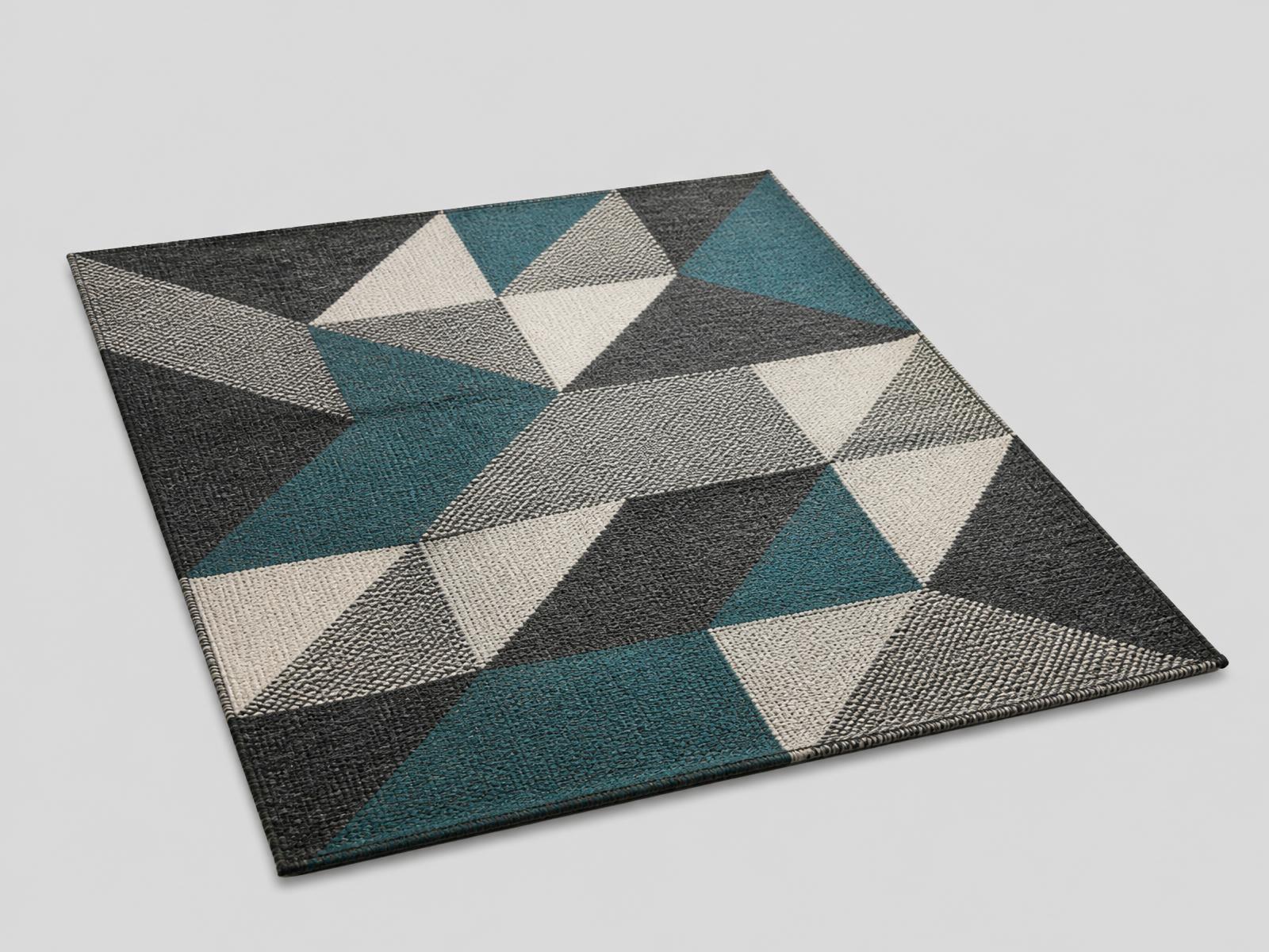 Geometric charcoal and teal patterned wool rug floating at an angle